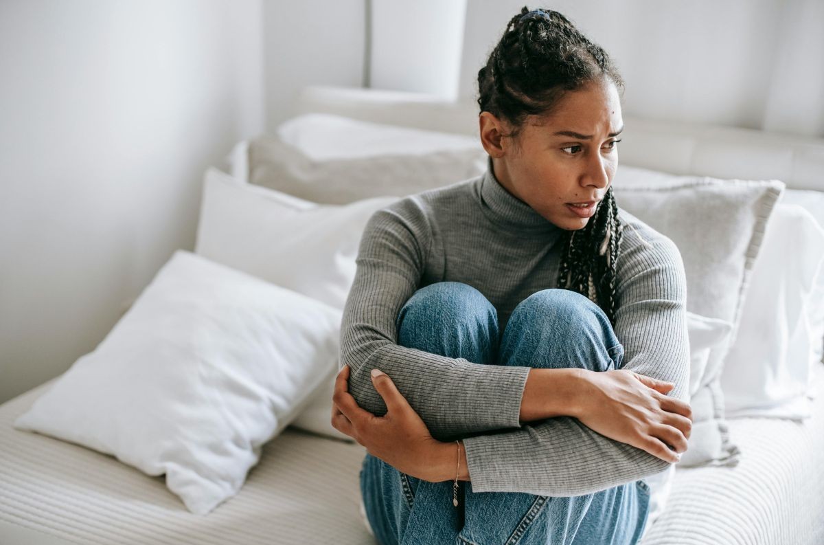 woman sitting quietly with eyes closed experiencing the shift from anxiety to calm — healing anxiety through the subconscious mind